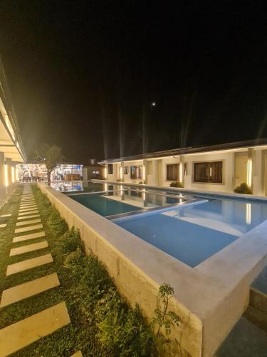a swimming pool at night in a building at Tagaytay Escapes Alfonso in Alfonso