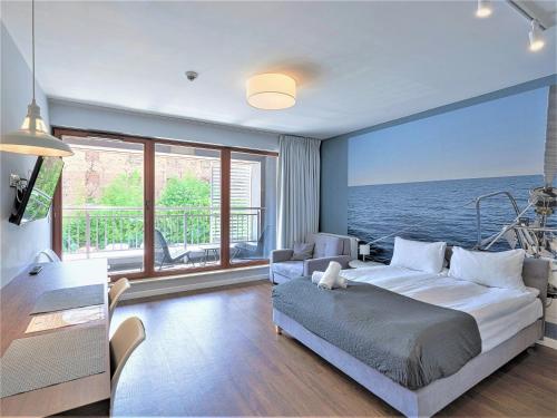 a bedroom with a bed and a view of the ocean at Zefiro Chmielna in Gdańsk