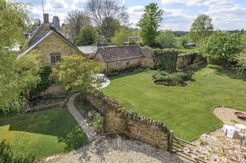 an aerial view of a house with a yard at Little Old Barn at Manor Farmhouse in West Chinnock