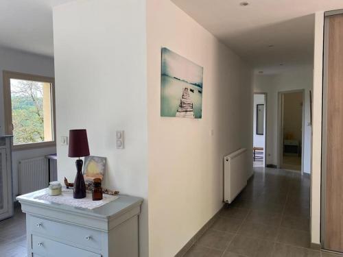 a living room with a table and a picture on the wall at Magnifique maison avec vue panoramique in Carlux