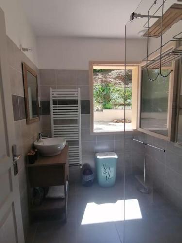a bathroom with a sink and a glass shower at Magnifique maison avec vue panoramique in Carlux