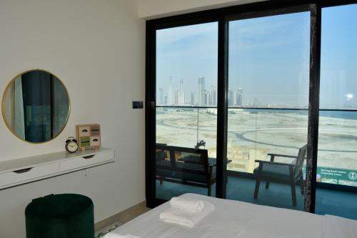 a room with a bed and a view of the city at Luxurious Smart Home in Dubai