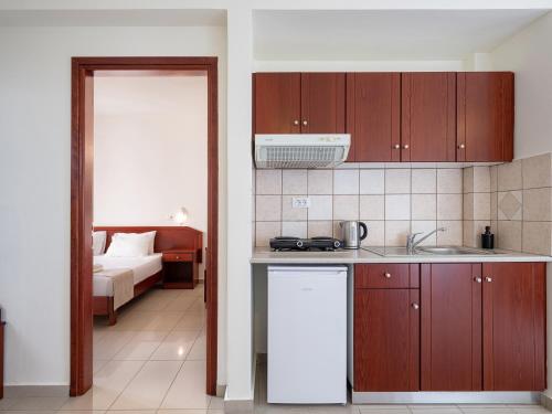 a kitchen with a sink and a counter top at Artemis Apartments in Stalos