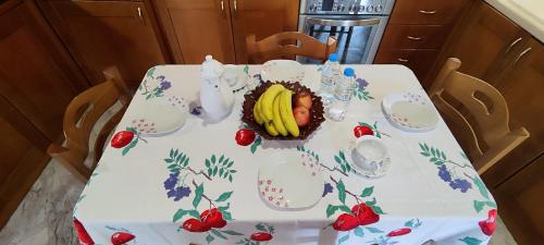 a table with a bowl of bananas on it at Theofania's Marble House Meteora in Kastrákion