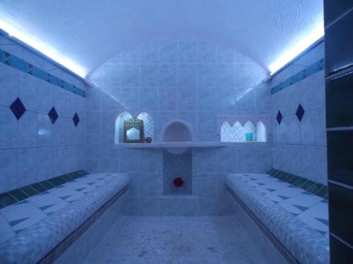 a bathroom with two benches and a red ball in it at Dormir Ben Aise Hammam Massages in Maillezais