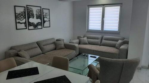 a living room with a couch and a table at Ohrid-Struga Ezerski Lozja in Struga