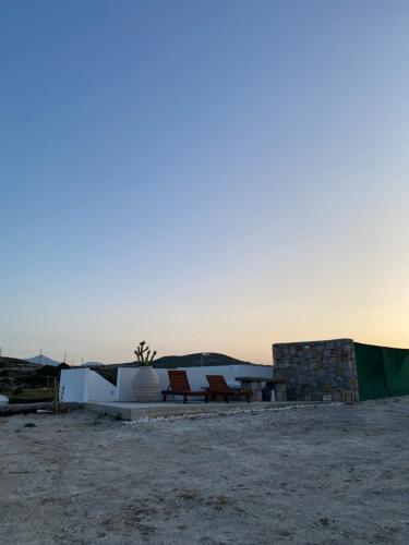 a group of chairs and a table in the desert at Amato in Mandrakia