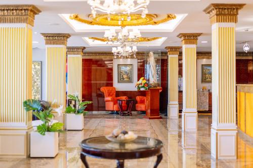 a lobby with columns and a chandelier at Monicca Collection Suites and Residences in Albufeira