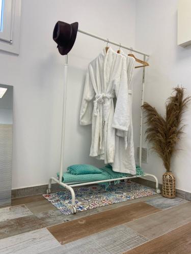 a towel rack with a white robe on it at Casa Mediterránea in Vilassar de Dalt