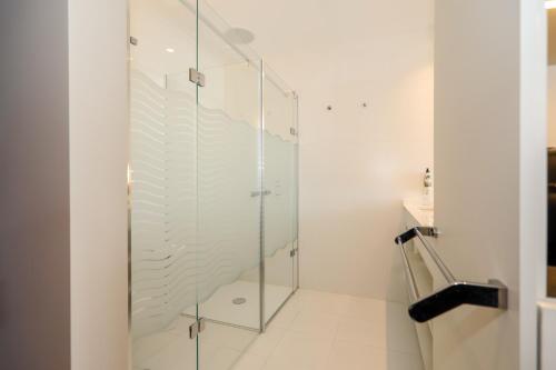 a glass shower stall in a white bathroom at Villa Paladina in Foz do Arelho