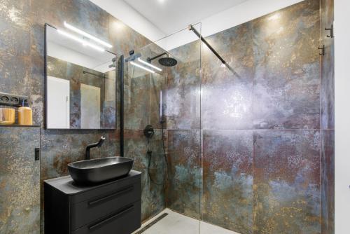 a bathroom with a sink and a glass shower at Apartments Villa Verde in Novigrad Istria