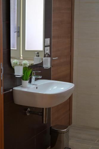 a bathroom with a white sink and a mirror at B&B Colle Acquabella in Ortona