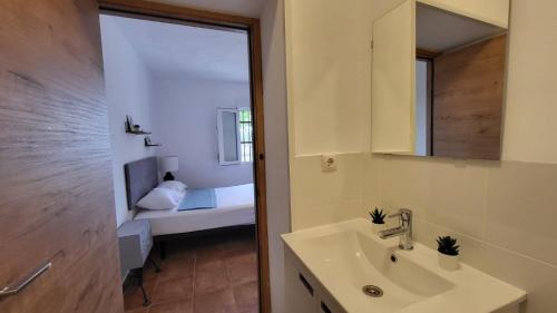 a bathroom with a sink and a mirror at HOSTAL SAN MARTIN DE MONTALBAN in San Martín de Montalbán