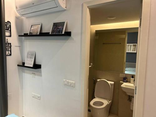 a bathroom with a toilet and a sink at London Studio @hiranandani thane in Thane