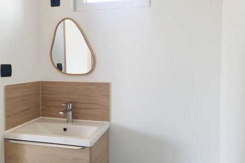 a bathroom with a sink and a mirror at Studio à la campagne in Saint-Yan