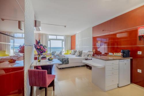 a kitchen and a living room with a couch at Monicca Collection Suites and Residences in Albufeira