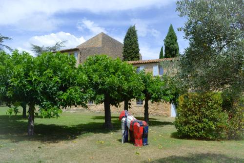 a house with a bunch of trees in front of it at Château Saint-Pierre de Mejans in Puyvert