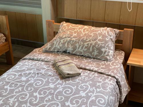 a bed with a pillow and a purse on it at Vista Point Apartment in Bajina Bašta