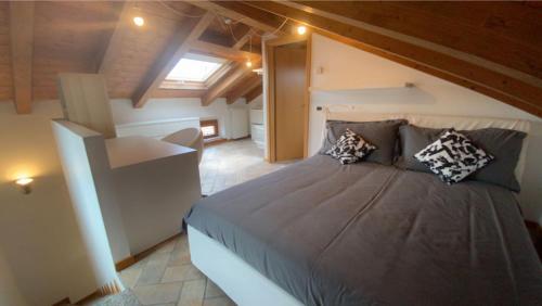 a bedroom with a large bed in a attic at BORGO CONTOVELLO in Trieste