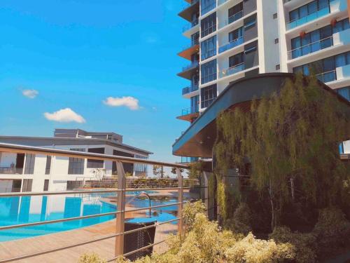 a hotel with a swimming pool and a building at Hanns Spacious Balcony&SwimPool with FREE Netflix-6pax in Sibu