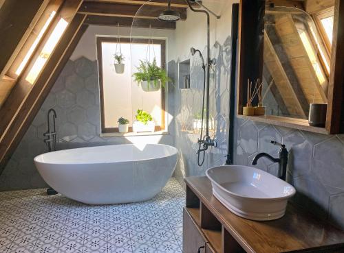 a bathroom with a large tub and a sink at Yaban Yasam Chalets in Yolcatı