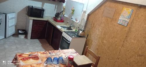 a kitchen with a table and a stove and a sink at Casanuestra in San Javier