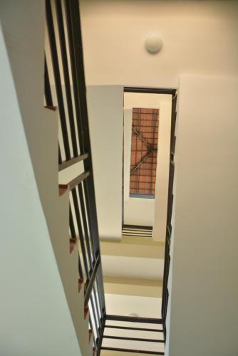 a hallway with black and white striped stairs at Neakru Guesthouse and Restaurant in Kampot