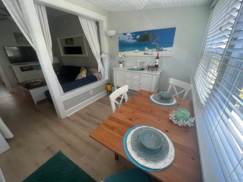 a room with a table and a bedroom with a bed at PAG Beachhouse Rentals in St Pete Beach