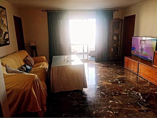 a living room with a couch and a glass floor at beach house in Marbella