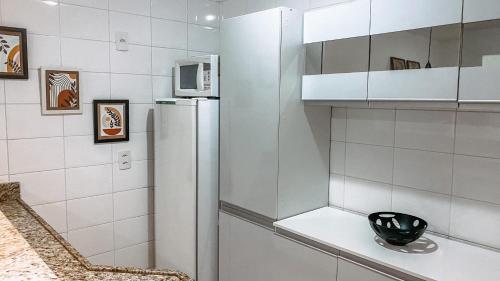 a kitchen with a refrigerator and a microwave at Apartamento no coração do Rio in Rio de Janeiro