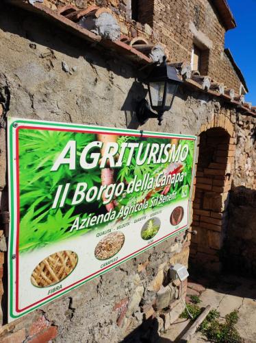 a sign on the side of a building at Agriturismo Il Borgo della Canapa in San Benedetto