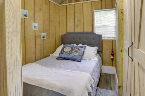 a small bedroom with a bed in a tiny house at Pet-Friendly Gulf Coast Rental Near Keaton Beach! in Perry