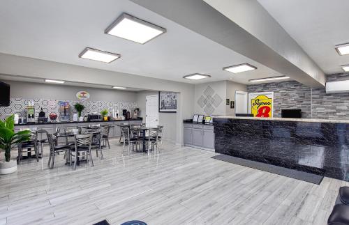 a restaurant with chairs and a bar in a room at Super 8 by Wyndham Nashville West in Nashville