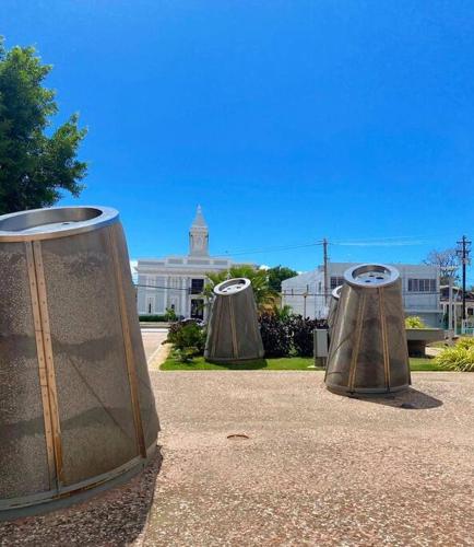 three metal containers sitting on the ground in front of a building at House Salinas - The best part of your getaway in Salinas