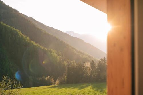 a view from a window of a field with a mountain at Balbeinhof Apt Hirsch in Luson