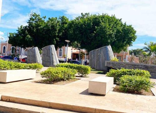 a park with white benches and trees and bushes at House Salinas - The best part of your getaway in Salinas