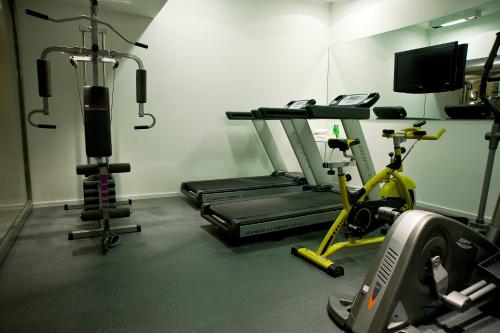 a gym with two tread machines and a treadmill at Awwa Suites & Spa in Buenos Aires