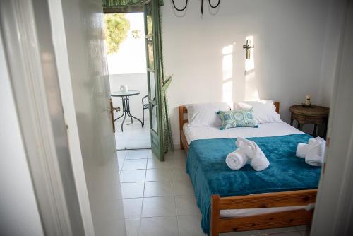 a bedroom with a bed with two shoes on it at Kos Gaia Garden House 