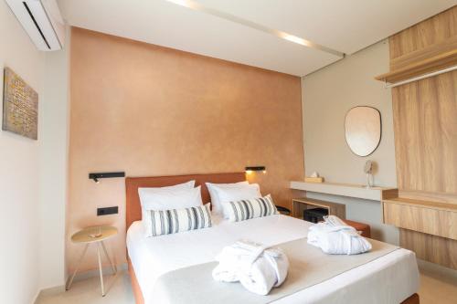 a bedroom with two white towels on a bed at STALèA Luxury Villa in Pefki Rhodes