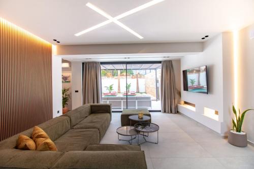 a living room with a couch and a table at STALèA Luxury Villa in Pefki Rhodes