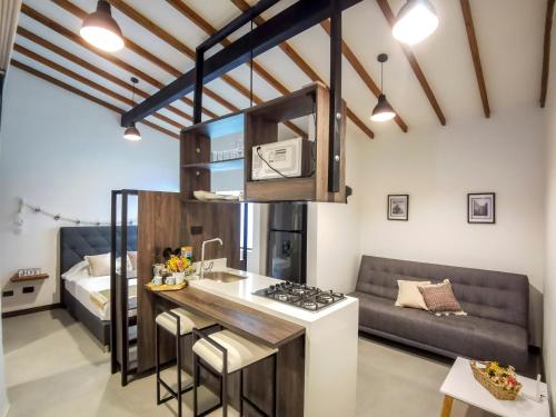a kitchen and living room with a couch at Casa García Rent Home in Guatapé