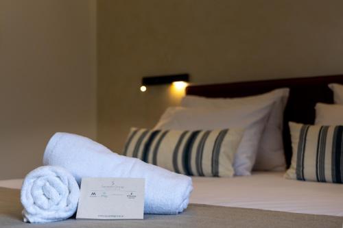a hotel room with a pile of towels on a bed at STALèA Luxury Villa in Pefki Rhodes