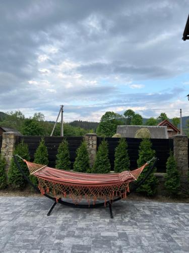 a hammock sitting on a patio in a garden at Arkan in Mykulychyn
