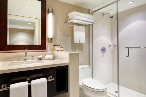 a bathroom with a sink and a toilet and a shower at Bungalows at The Boca Raton in Boca Raton
