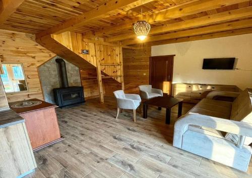 a living room with a couch and a fireplace at Etno selo Zminica in Žabljak