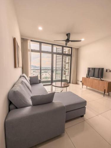 a living room with a couch and a flat screen tv at [Starry x DELUX] 8-10pax *free Netflix access in Masai