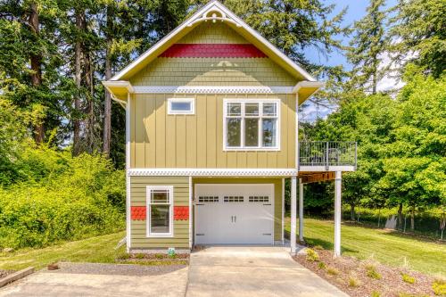 a yellow house with a gambrel roof and a garage at River Gorge View in Stevenson