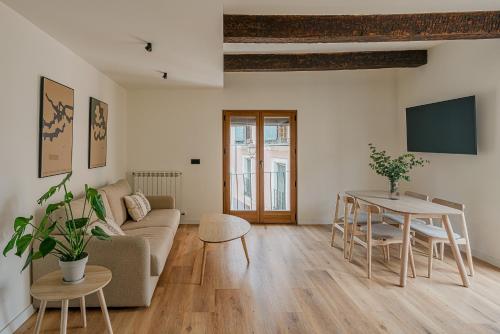 a living room with a couch and a table at El Jardinillo del Salvador in Cuenca