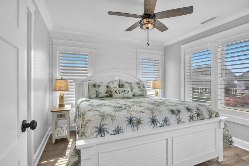 a bedroom with a bed and a ceiling fan at Weekend Rescue in Oak Island