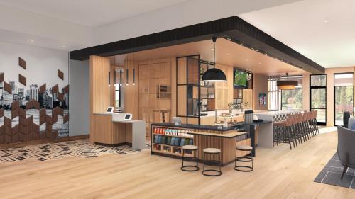 a kitchen and living room with a counter and chairs at Hyatt Place Boise-Meridian in Meridian